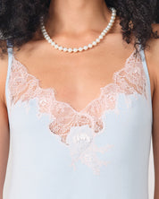 Effetto bamboo chemise spaghetti strap 03162 – women's sleepwear, icy blue
Light blue lace-trimmed top worn by a person with a pearl necklace.