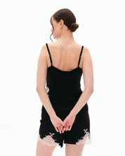 Effetto bamboo cami shorts set 03163 – women's sleepwear, black

Woman wearing a black slip dress with lace trim on a white background